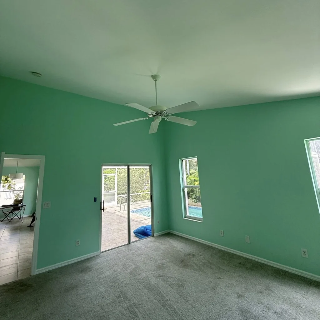 Interior living room space with walls painted green by Regalbuto Contractors