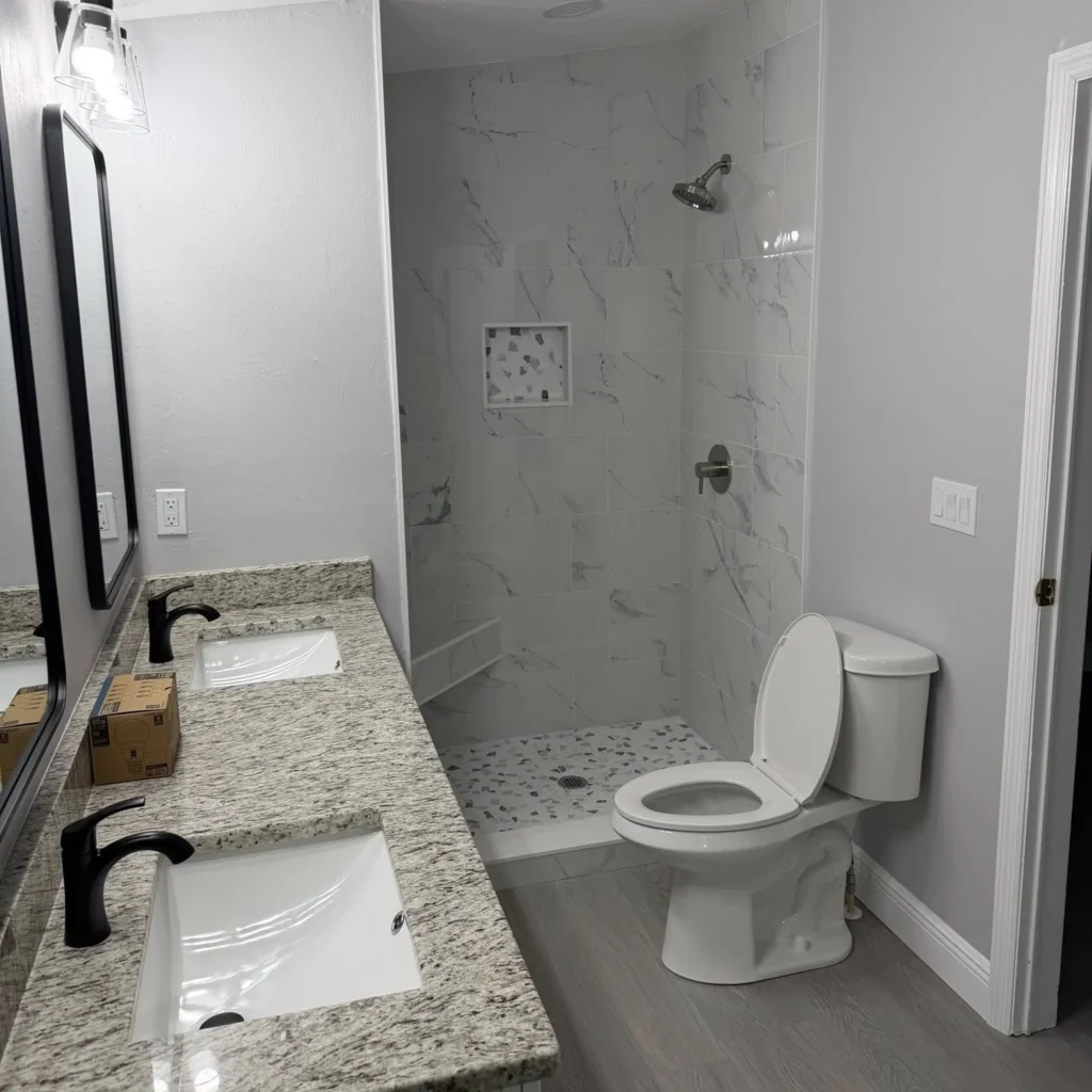Remodeling of a white themed bathroom carried out by Regalbuto Contractors