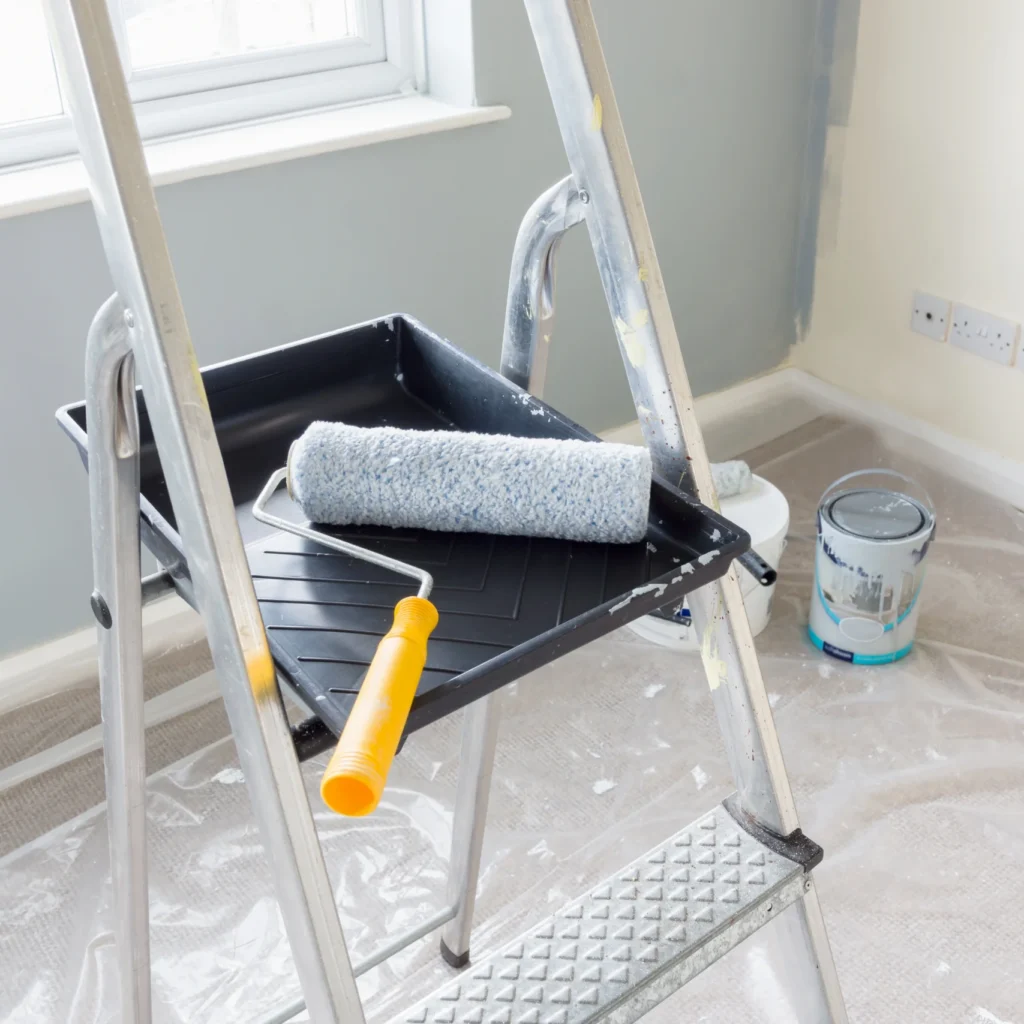 Paint brush on stepping stool representing painting services by Regalbuto Contractors