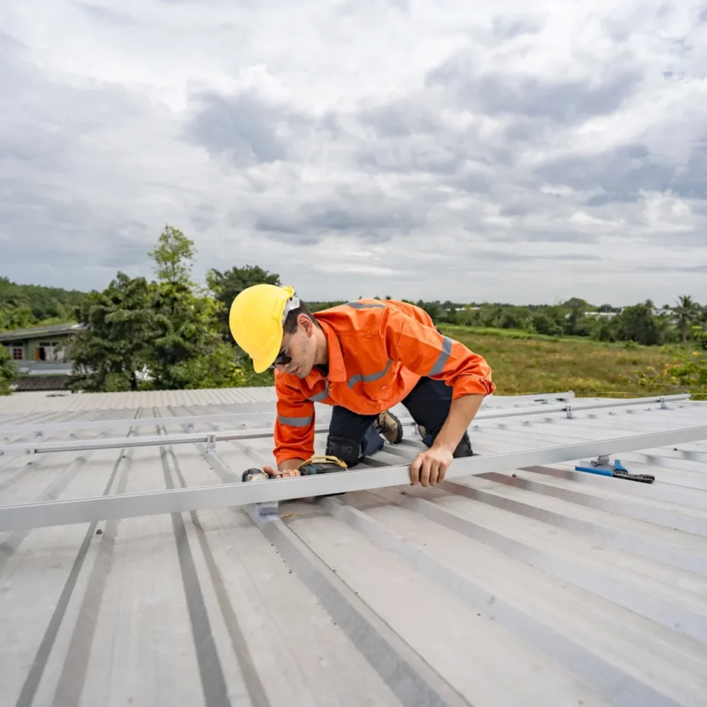 Roofer working on the structure of a metal roof